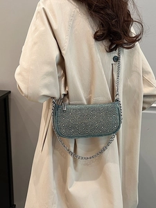 Chic sage green rhinestone crossbody bag with silver chain strap shown on model