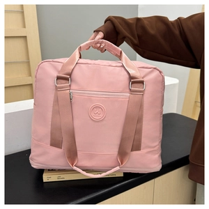 Macro view of water-resistant pink travel bag fabric with zipper pocket and rubber logo