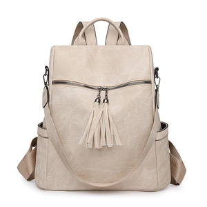Detail view of beige PU leather backpack featuring tassel zippers and side pockets