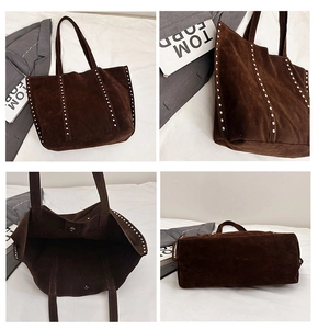 Detail view of brown suede tote bag with silver studs and magnetic snap closure