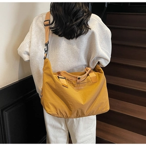 Spacious yellow gym bag for travel and sport with adjustable shoulder strap and handles