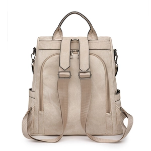 Detail view of beige multi-functional backpack with wide straps and smooth metal hardware