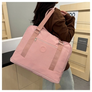 Detail of pink waterproof oxford travel bag with adjustable strap and front zipper pocket
