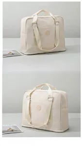 Close-up of cream travel bag showing waterproof fabric texture and side pocket detail