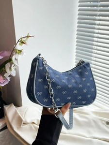 Blue denim crescent shoulder bag with white bow embroidery and silver chain strap