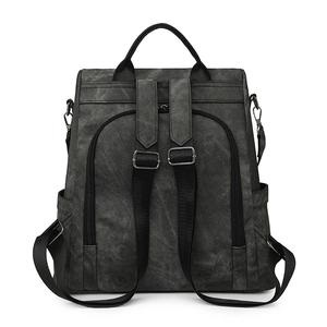 Detail view of the backpack back straps with metal adjustment buckles and dark grey canvas texture