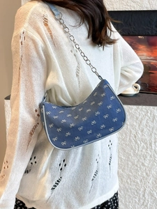 Denim crescent shoulder bag with white bow embroidery and silver chain strap
