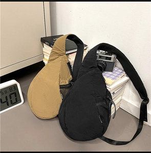 Close-up of stylish nylon chest bags in khaki and black with mesh side pockets