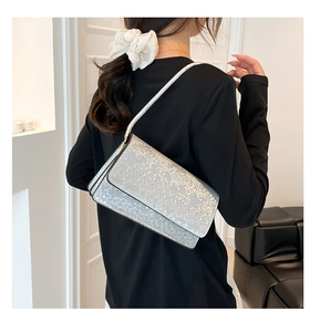 Silver snakeskin pattern shoulder bag with metallic scale texture and sleek flap design