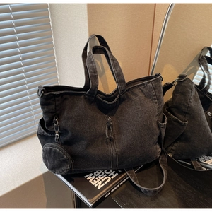 Black washed denim tote bag featuring vintage texture and a small round coin purse charm
