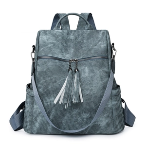 Detail view of the vintage gray-blue faux leather backpack with tassel zippers and straps
