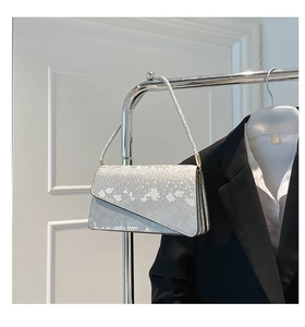 Detail of silver snakeskin shoulder bag with unique asymmetrical diagonal flap design
