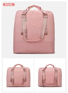 Pink waterproof travel duffel bag with expandable bottom and trolley sleeve detail