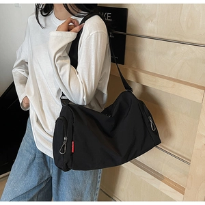 Detail of black waterproof sports bag with adjustable strap and silver metal zipper