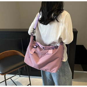 Lavender waterproof travel duffel bag showing model back view in a modern home setting