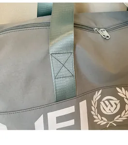 Close-up of reinforced stitching on the durable nylon handle of a large sports travel bag