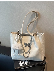 White pleated leather tote bag with silver butterfly, chain, and cloud charm