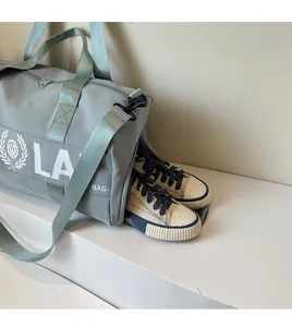 Grey sports gym bag featuring a dedicated side zippered shoe compartment for travel
