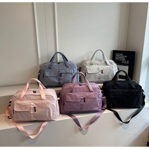 Lightweight multi-color travel bags displayed in pink, purple, grey, and beige tones