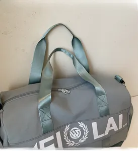 Detail of blue-grey gym bag showing durable nylon texture and sturdy dual handles