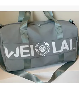 Detail of grey fitness bag with WEILAI logo on a clean indoor decorative stand