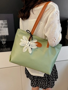 Large light green PU leather tote bag with orange straps and floral charm for women