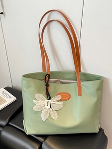 Large light green leather tote bag with orange straps and daisy charm for women