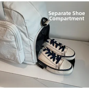Detail view of the dedicated shoe compartment in the large travel bag for organization