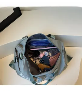 Interior view of light blue gym bag showing large capacity for water bottle and accessories