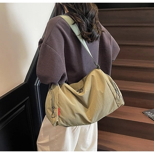 Detail view of khaki fitness travel bag with durable metal zippers and a side pocket
