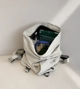 Detail van de grote binnencapaciteit van de lichtgrijze rolltop rugzak met apparaten