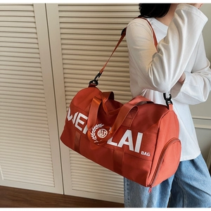 Detail of red sports duffel bag showing side zipper shoe compartment and WEILAI branding