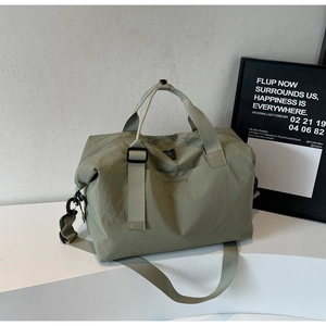 Close-up of Morandi green travel bag with wellallbag embossed logo and black hardware