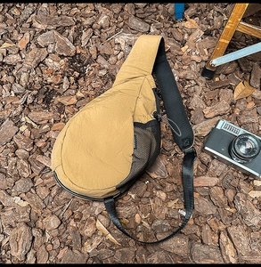 Detail of khaki oxford cross-body chest bag with breathable mesh and wide shoulder strap