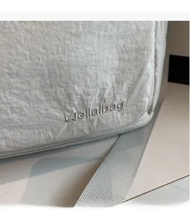 Detail of Wellalbag embroidery and textured fabric on lightweight travel bag