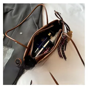 Interior view of large brown soft leather tote bag showing spacious capacity and pockets