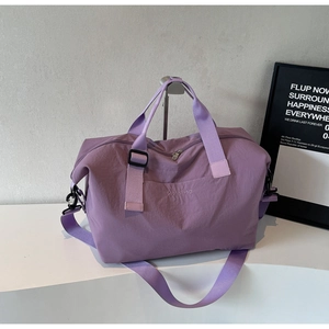 Purple waterproof travel bag detail with Wellallbag logo and adjustable shoulder straps