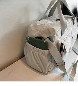 Close-up of durable elastic side pocket on large nylon travel bag holding a tablet