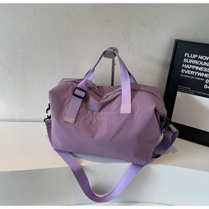 Detail of lavender travel bag showing wear-resistant nylon fabric and strap hooks
