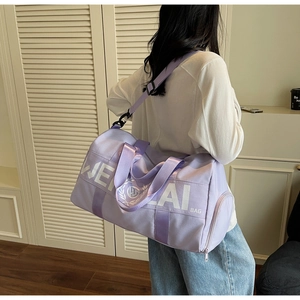 Lavender canvas fitness bag worn by a model in a cozy indoor minimalist setting