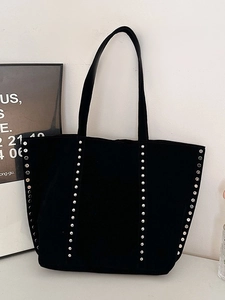 Minimalist black faux suede tote bag with silver rivet studs and long shoulder straps