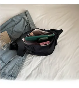 Internal view of black nylon crossbody bag showing spacious capacity for daily essentials