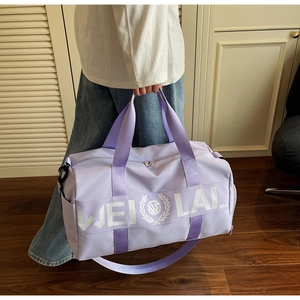 Detailed view of lavender purple sports bag with shoulder strap in home setting