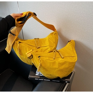 Detailed set of bright yellow crescent crossbody bags in lightweight nylon fabric