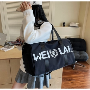 Model showcasing a large capacity black Oxford fabric travel bag with WEI LAI logo