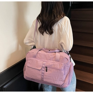 Lightweight purple travel bag with wet-dry separation shown on model on stairs