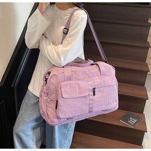 Lifestyle shot of a light purple waterproof travel bag with spacious storage and straps
