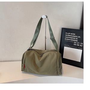 Olive green nylon gym bag with adjustable shoulder strap and large side zipper pockets