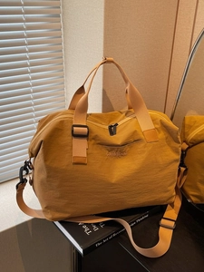 Large capacity travel duffel bag in mustard yellow with adjustable strap for sport and gym