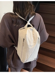 Off-white large capacity canvas backpack shown as a stylish shoulder bag on a model